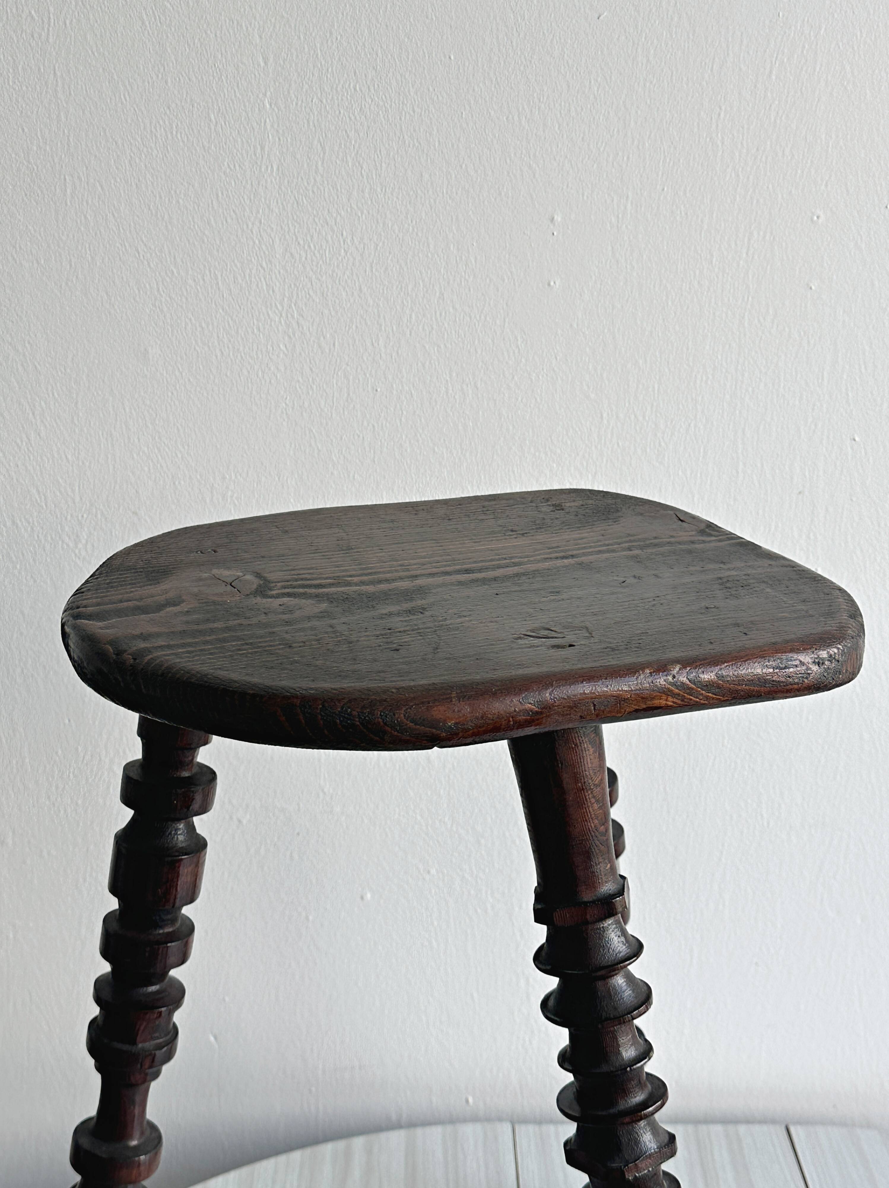 Antique dark wood tripod stool