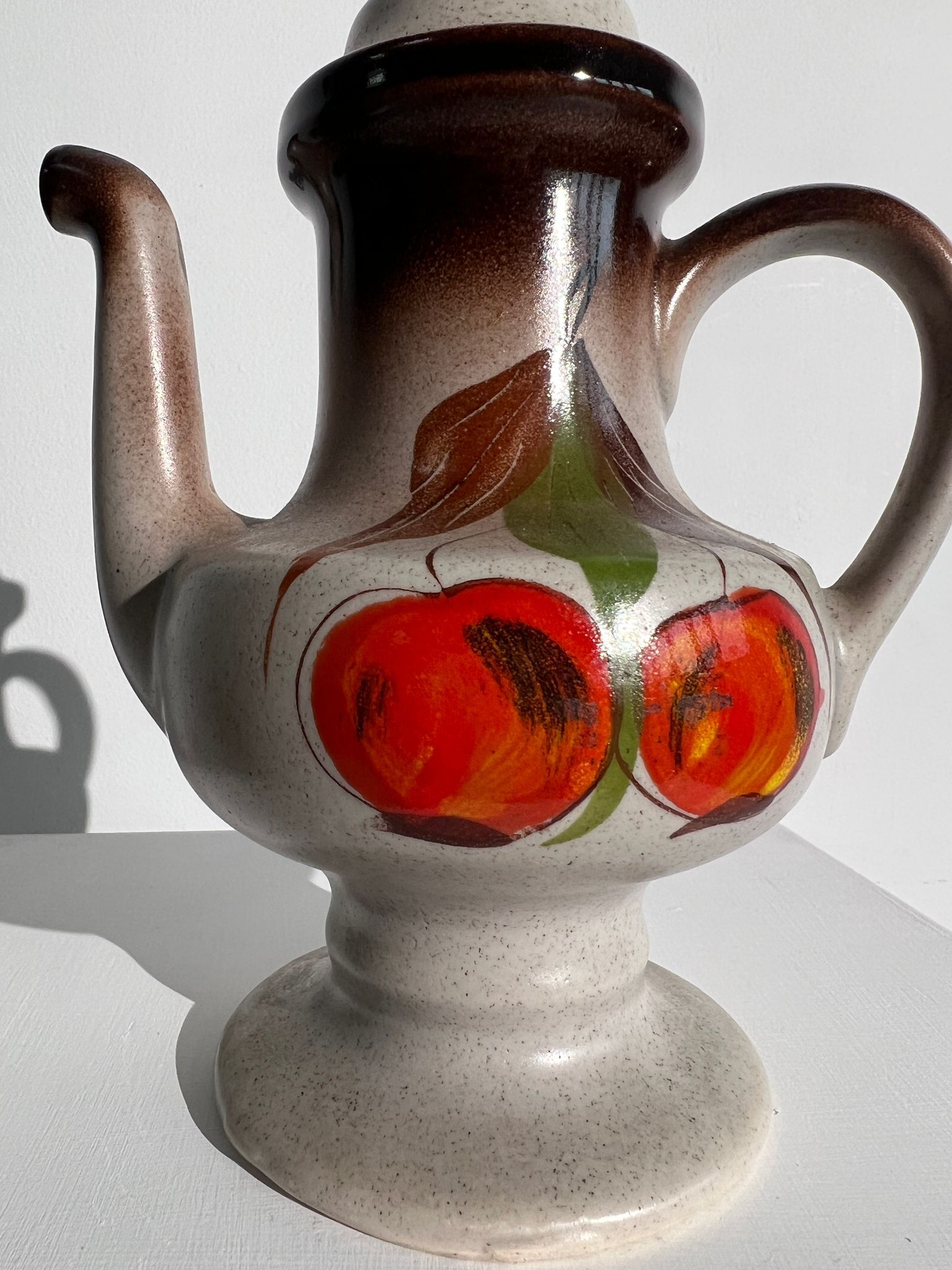 Vintage stoneware teapot with flower and fruit patterns