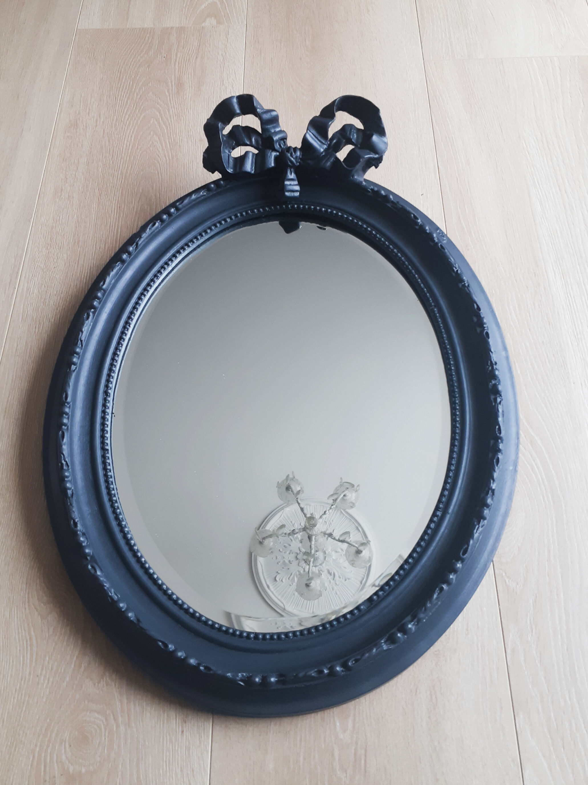 Louis XVI oval mirror with knot, black patinated, vintage