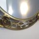 Round gold metal mirror, rose crown