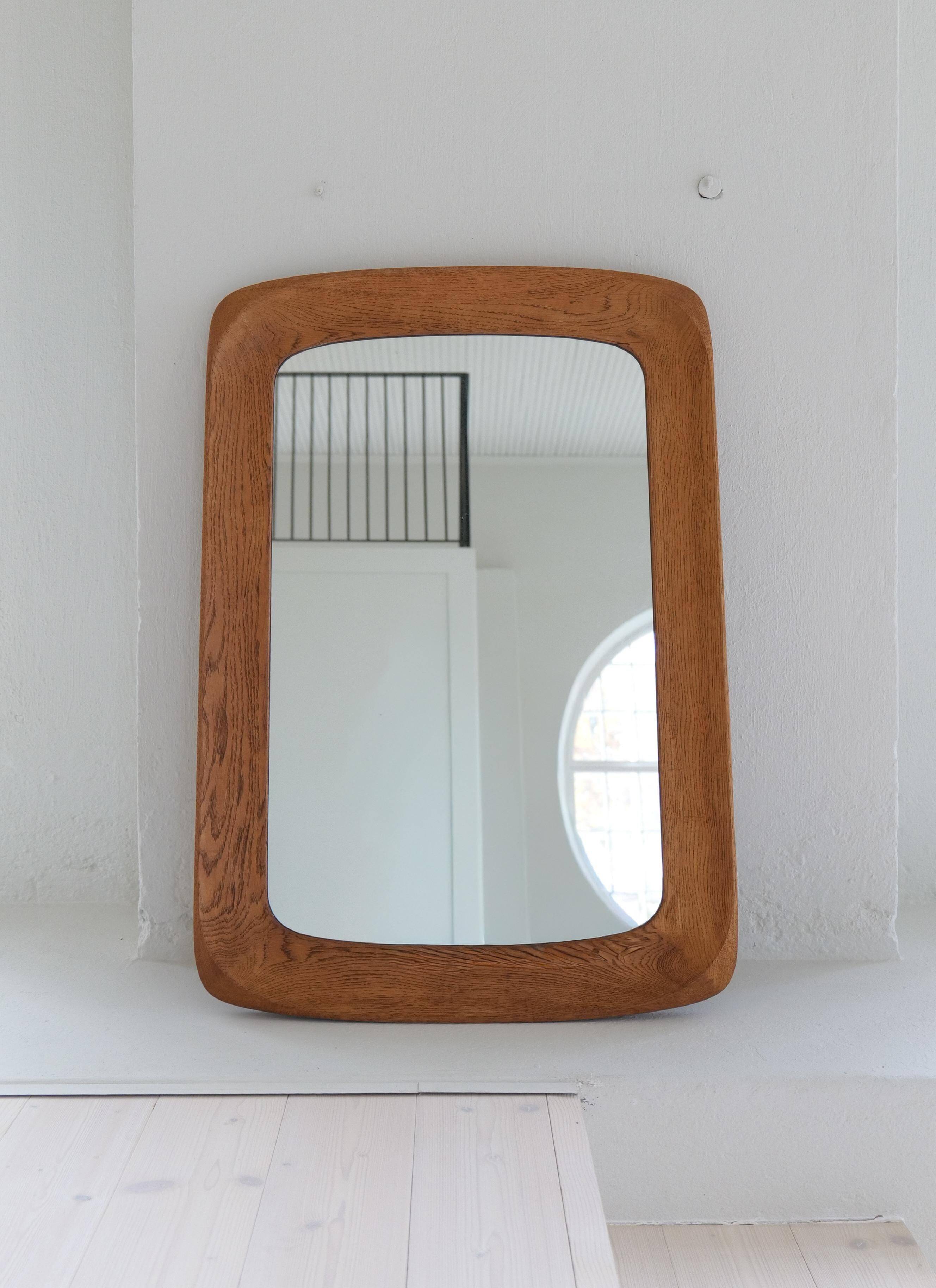 Mid-century modern sculptural wall mirror in stained oak, glass, Glas & Trä 1959