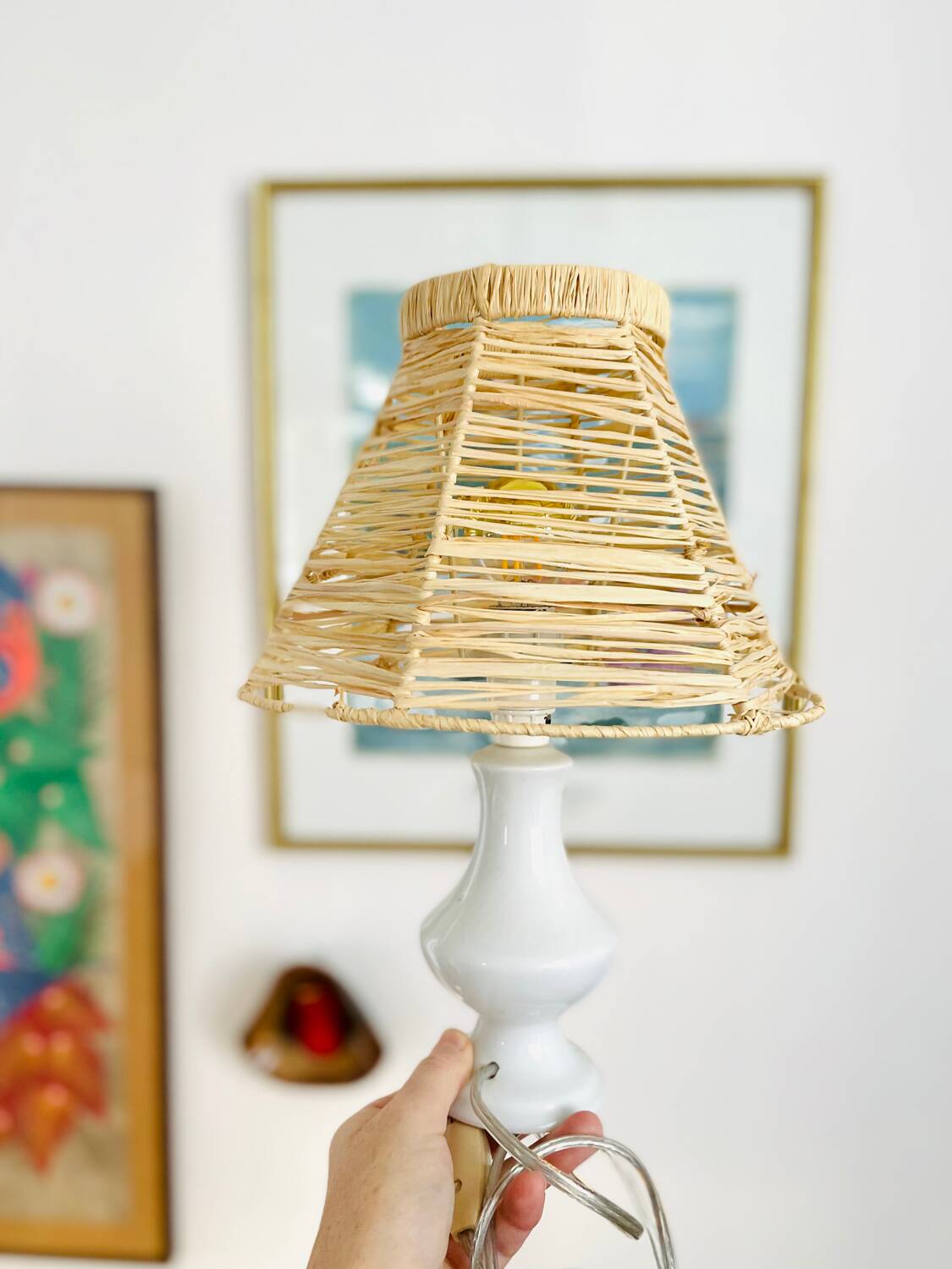 White porcelain table lamp and vintage raffia lampshade