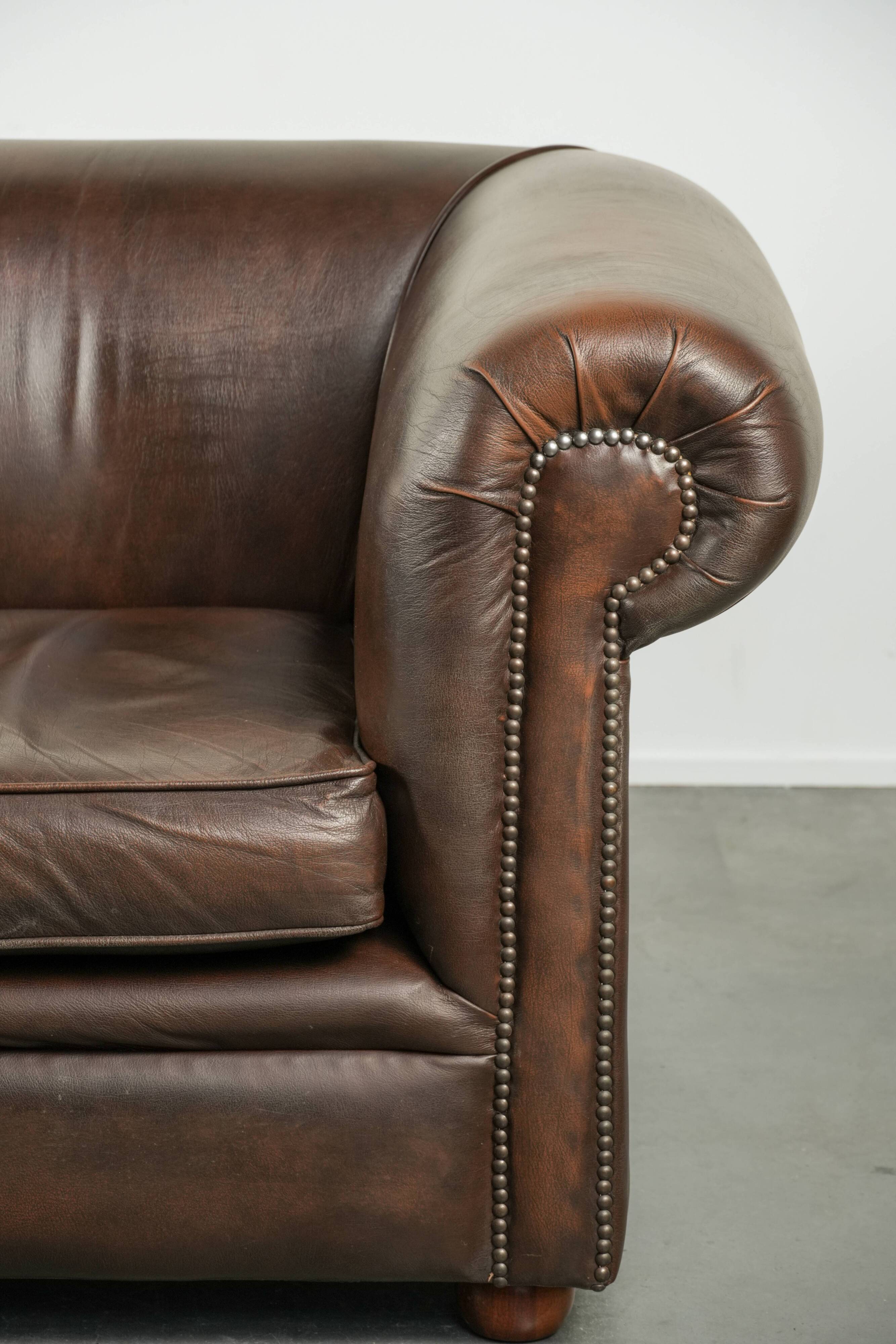 Luxury brown smooth cow leather Chesterfield sofa with an English look