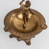 Vintage brass ashtray from the 1940s with a nude boy figurine on a footed base.