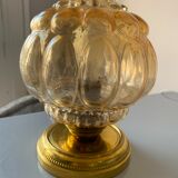 Old vintage table lamp made of amber molded glass