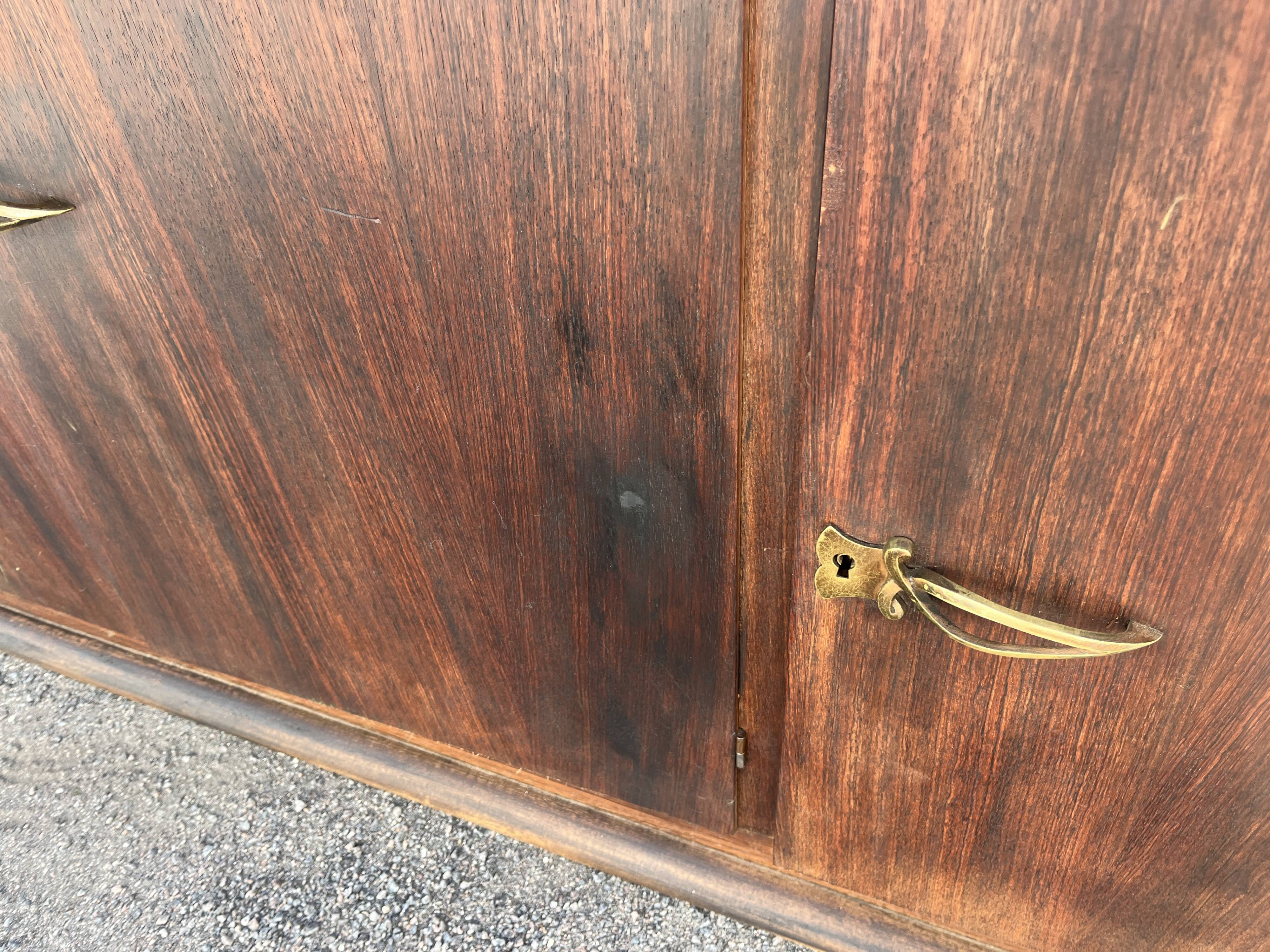 Asymmetrical antique Art Deco sideboard in rosewood veneer.