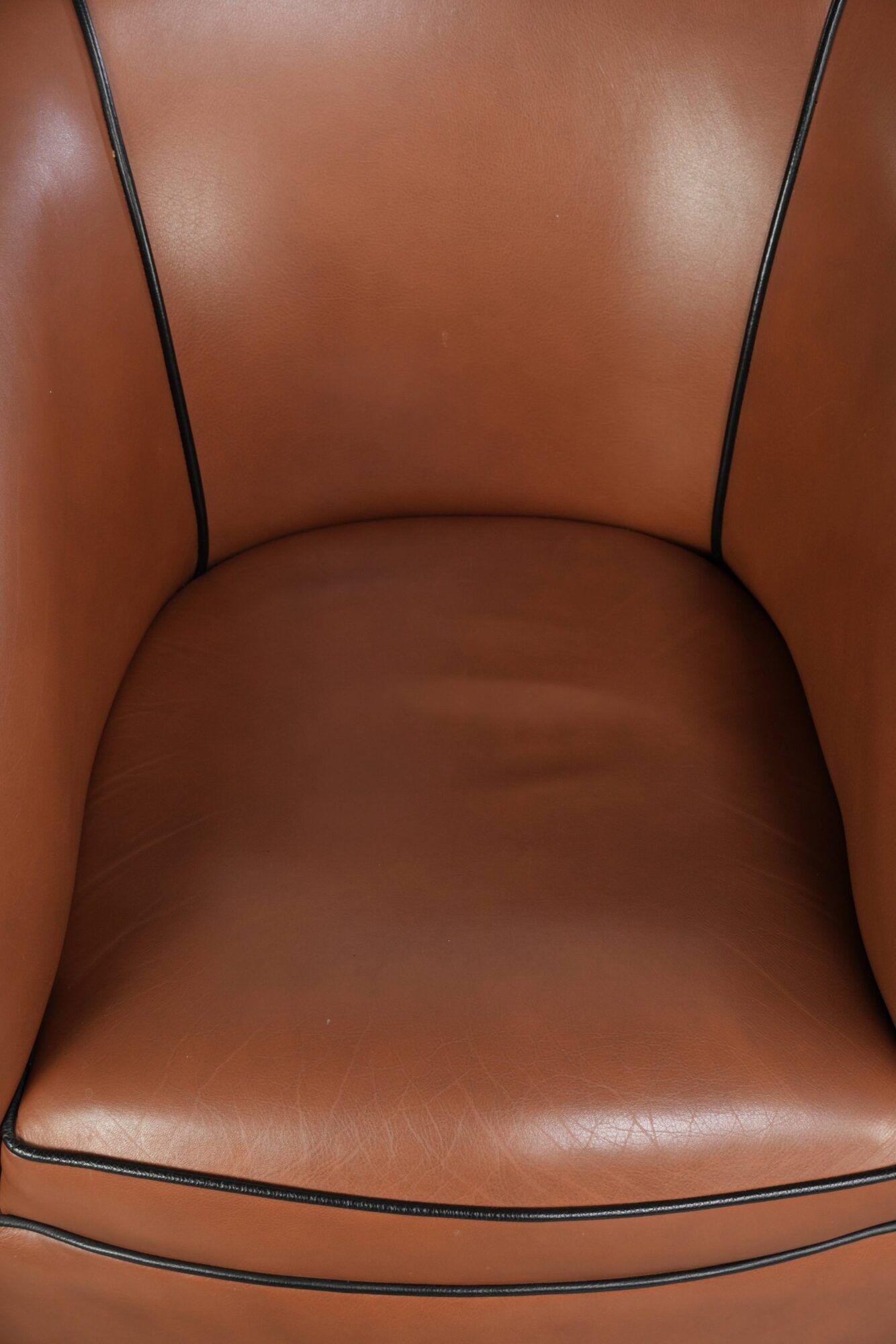 Cowhide club armchair in English style with comfortable seating.