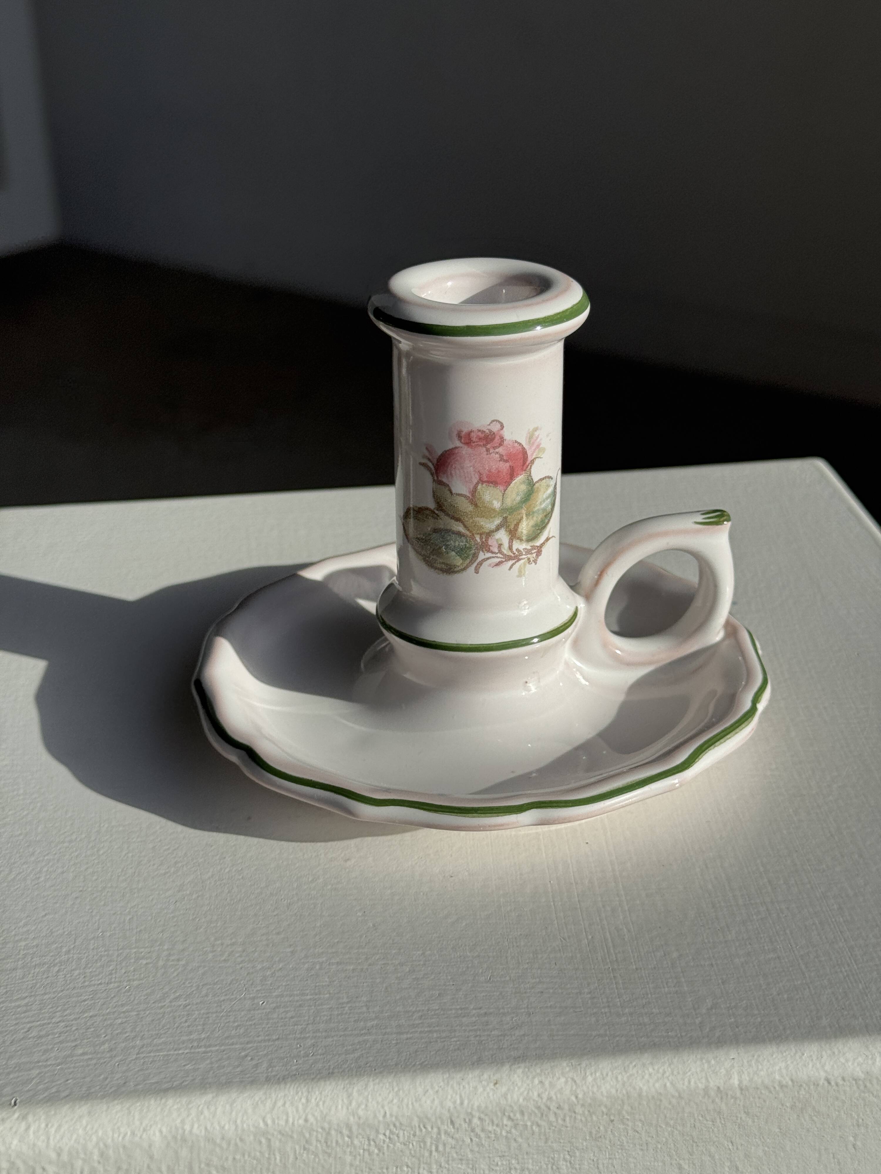 Small vintage hand-held candlestick in earthenware with green trim and floral decoration H10.5