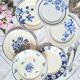 Mismatched antique flat plates accompanied by dishes.
