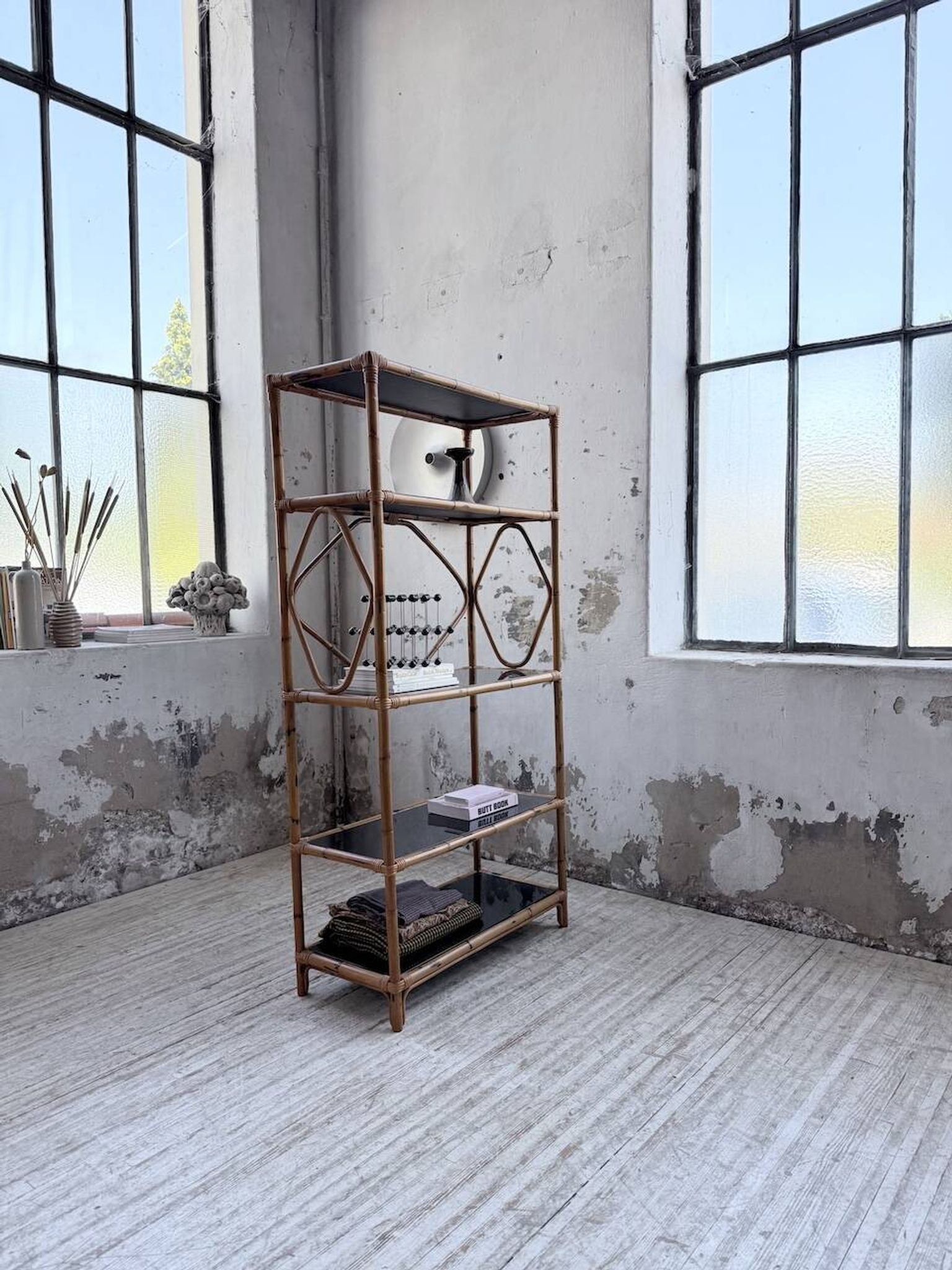 Rattan bookshelf and black glasses