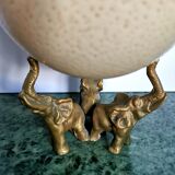 Ancient ostrich egg naturalized on bronze base representing 3 elephants