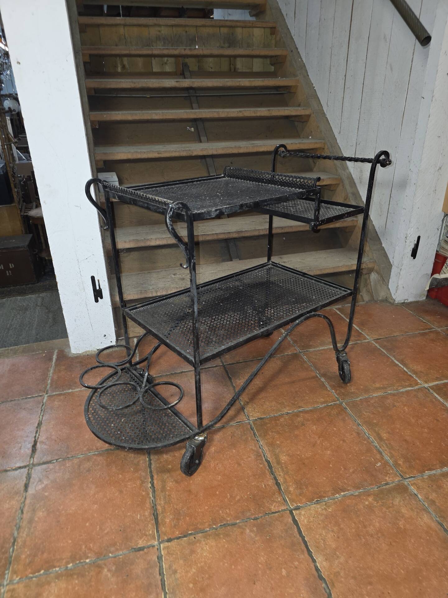Perforated wrought iron rolling dessert trolley