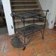 Perforated wrought iron rolling dessert trolley