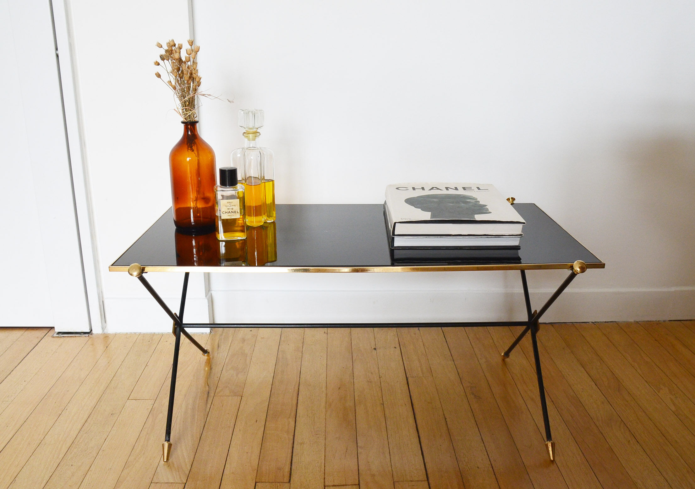 Black glass and brass coffee table in the 1960s