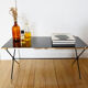Black glass and brass coffee table in the 1960s