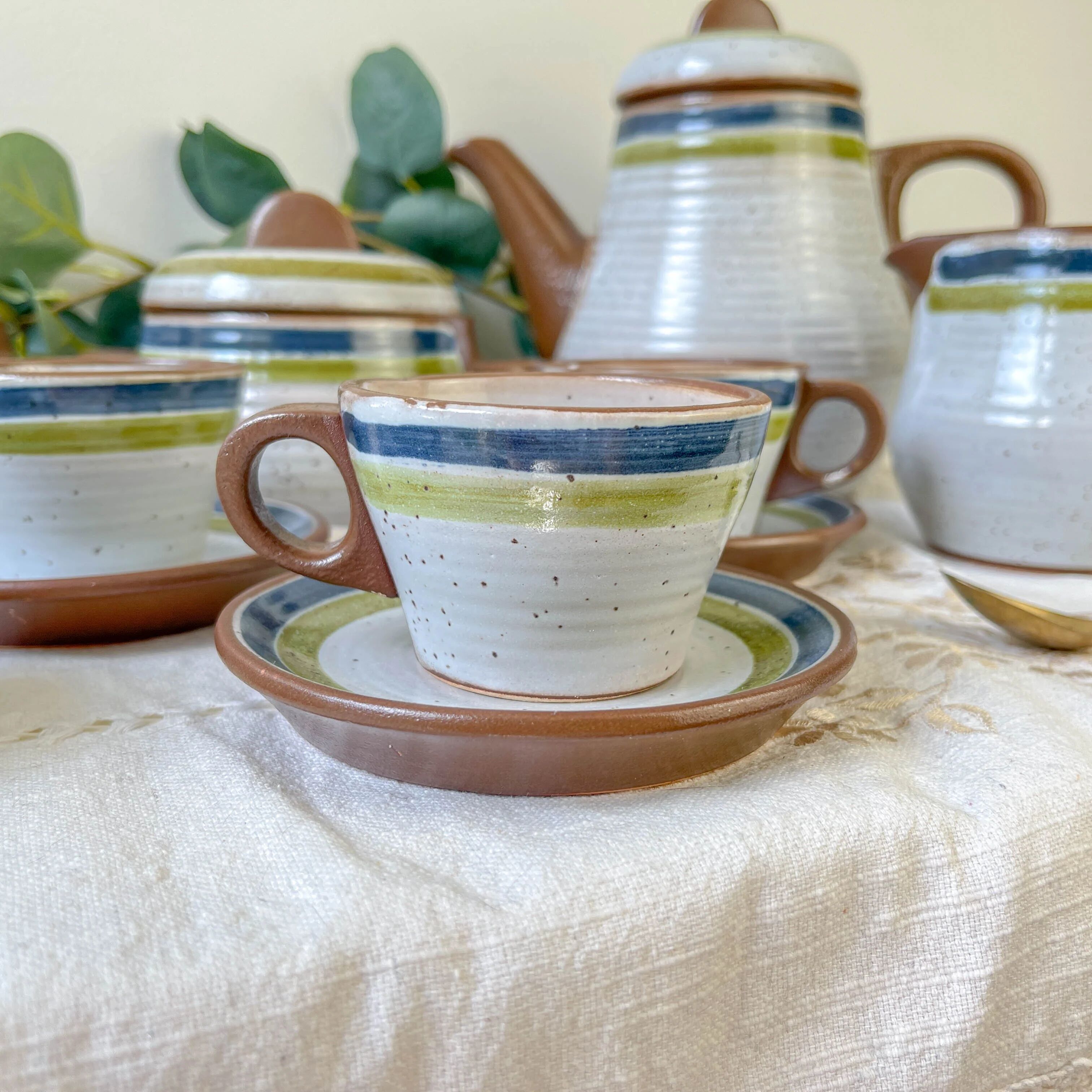 Vintage 1950s speckled stoneware coffee set with grey, green, and blue stripes