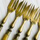 Set of 8 vintage gold metal dessert forks