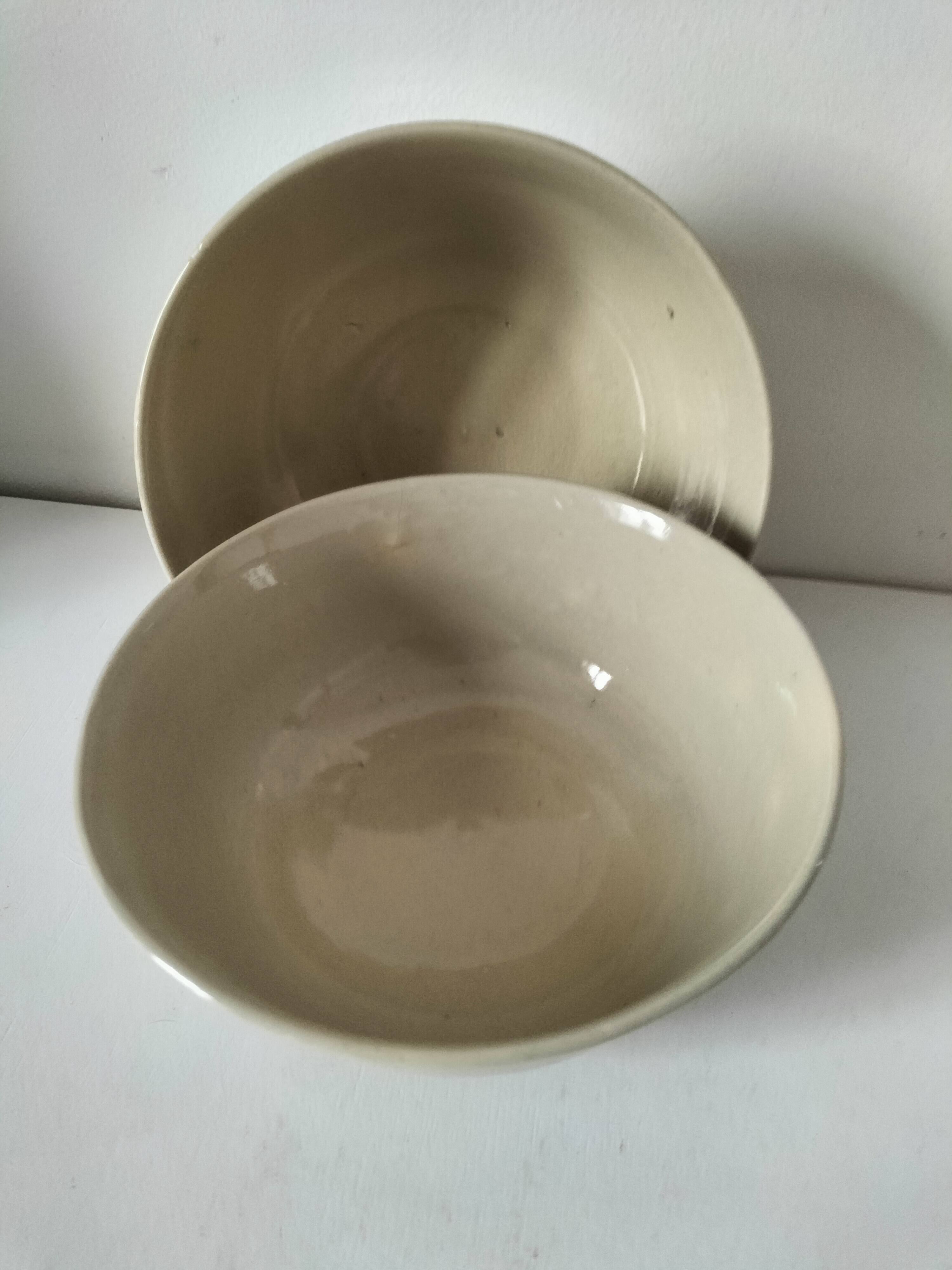 Two large vintage bowls in pastel decor on mini pedestals.