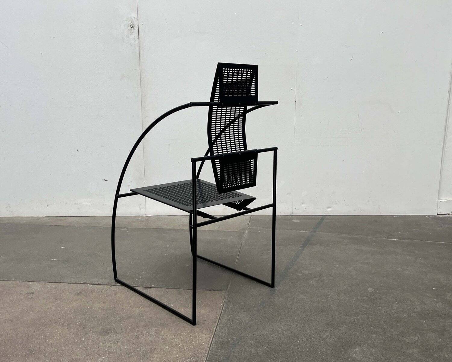 Postmodern black Quinta chair in perforated metal by Mario Botta for Alias, 1980s.