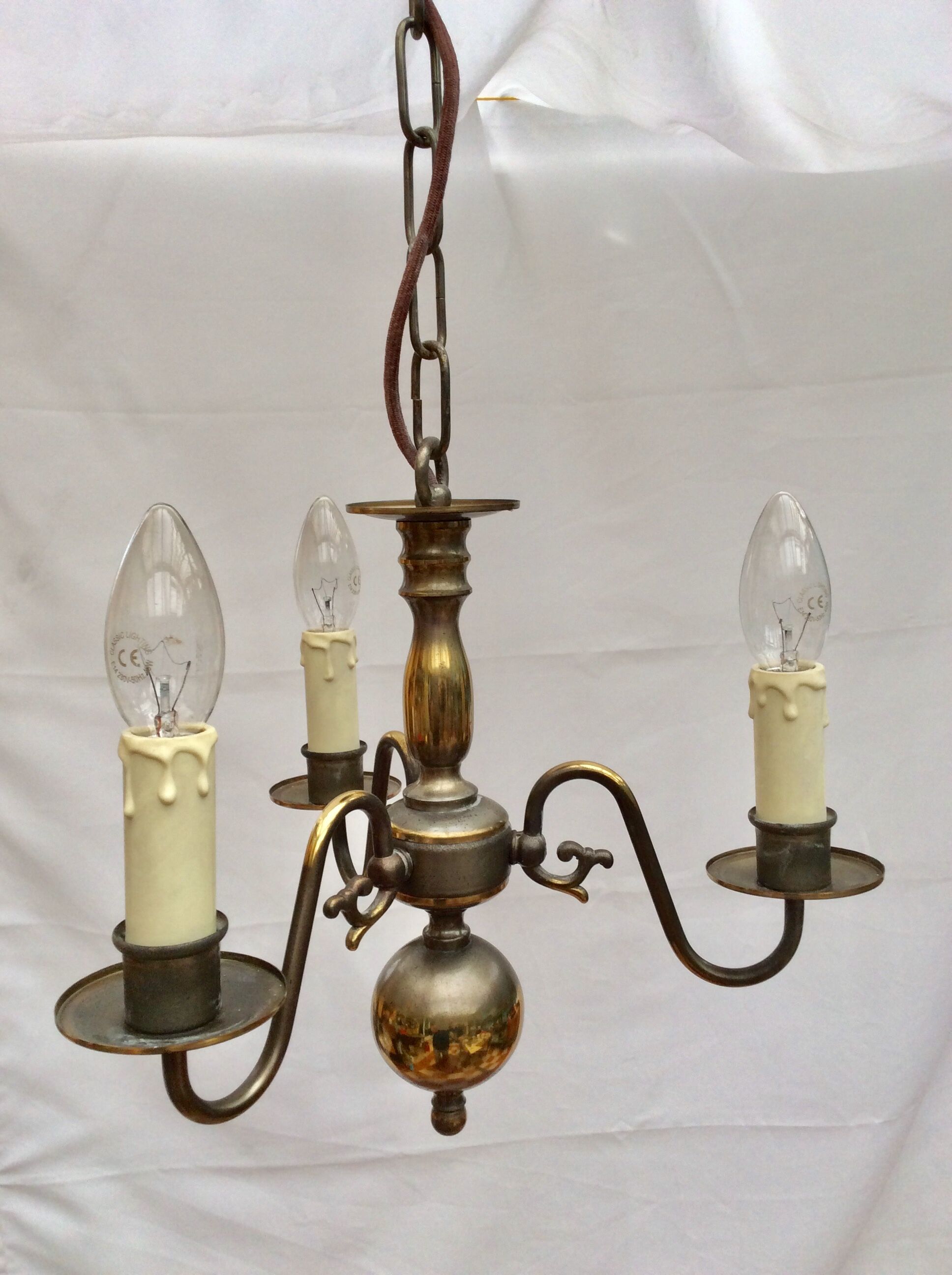 Metal chandelier repainted in copper color with 3 candle-shaped bulbs