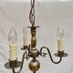 Metal chandelier repainted in copper color with 3 candle-shaped bulbs