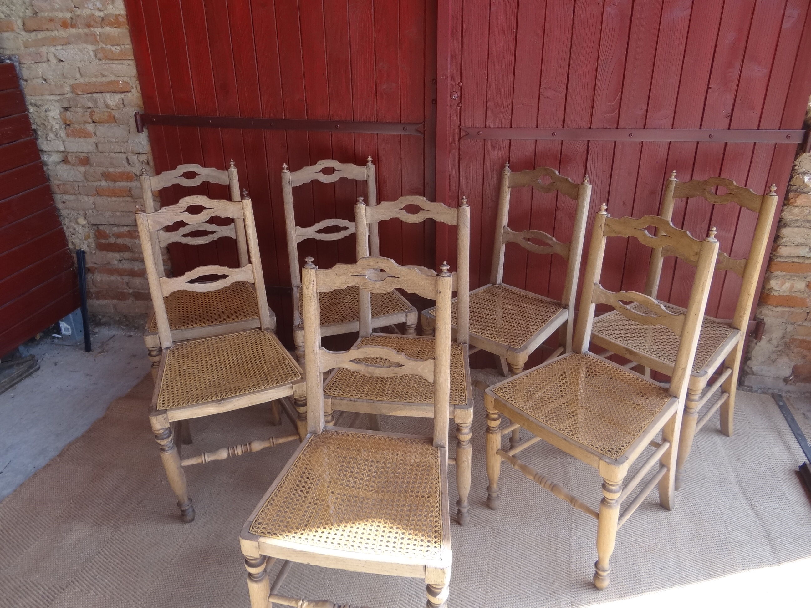 Suite of oak chairs; canated seats