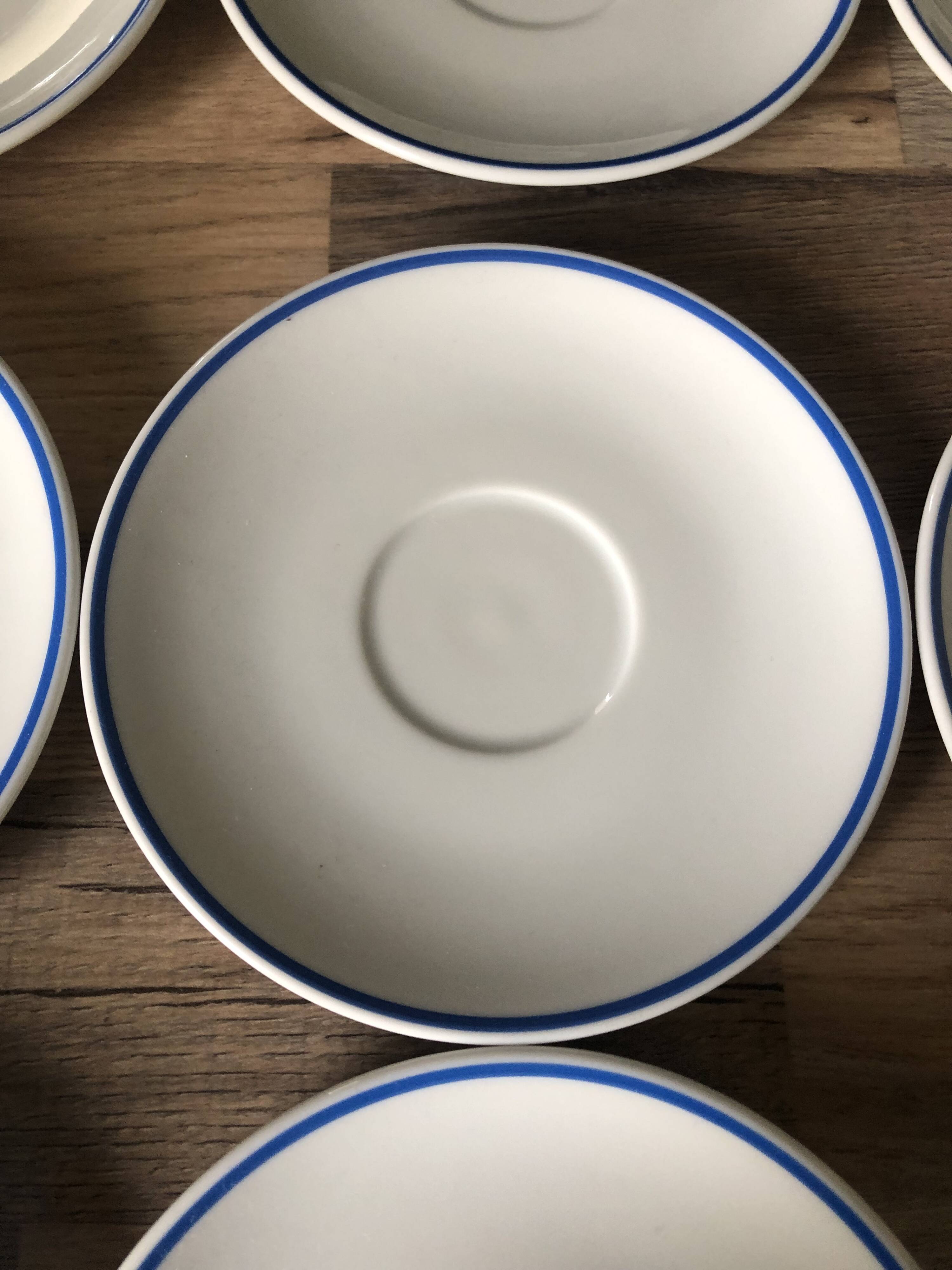 Set of 12 white porcelain saucers with blue edging