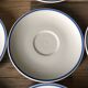 Set of 12 white porcelain saucers with blue edging
