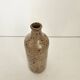 Pyrite stoneware single-flower vase in the shape of a bottle signed Aular?