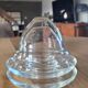 2 egg cups with matching glass cloches in transparent glass