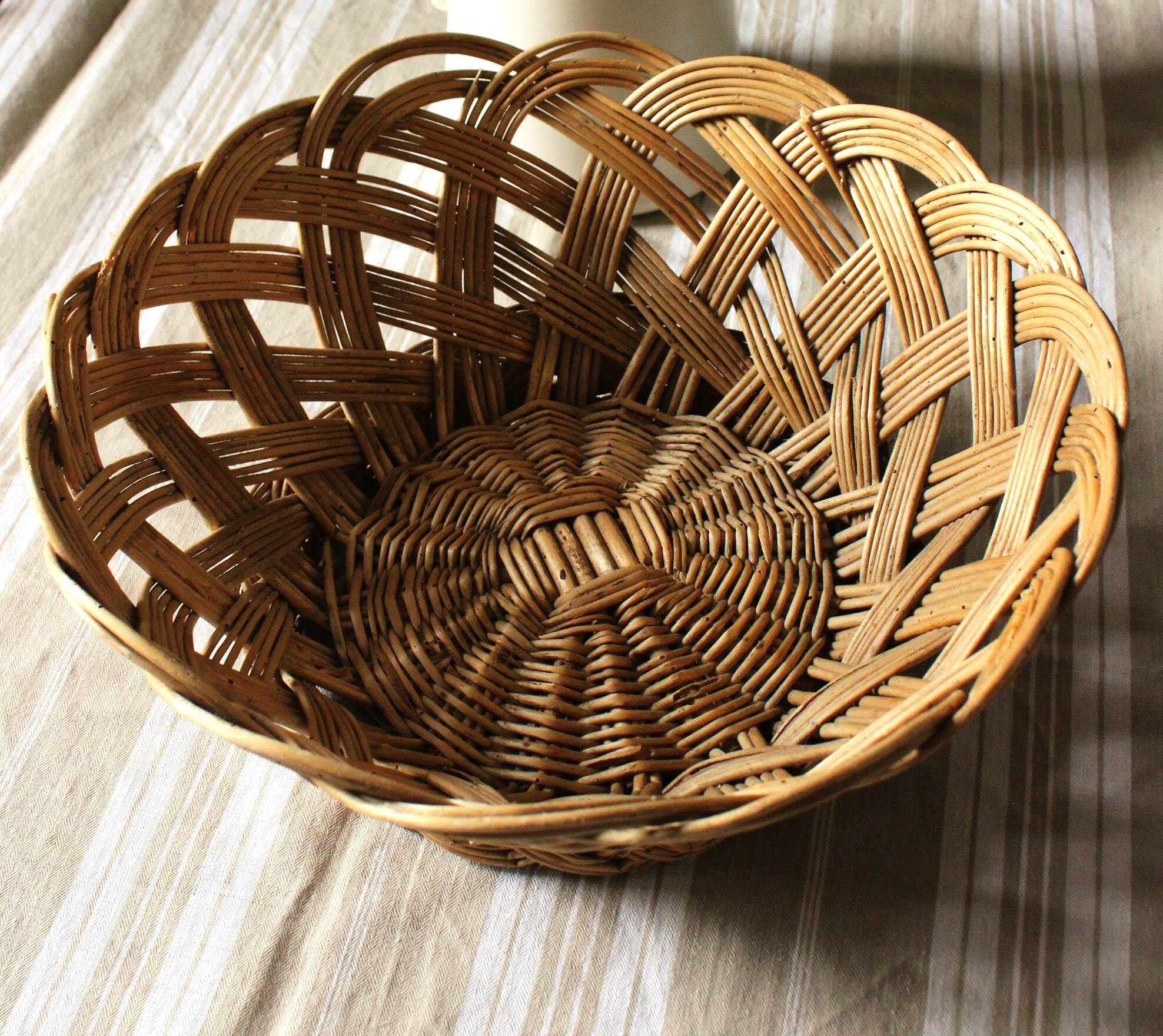 Large vintage twisted wicker basket on a stand