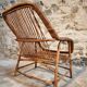 Vintage rattan lounge set, French wicker armchairs and round table, circa 1930–1950.