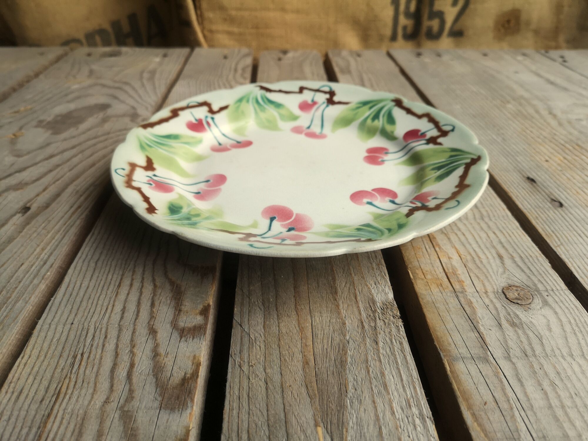 Old decorative plate in barbotine by luneville cherry motif