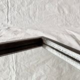 Vintage wall mirror in varnished steel decorated with a rose in relief