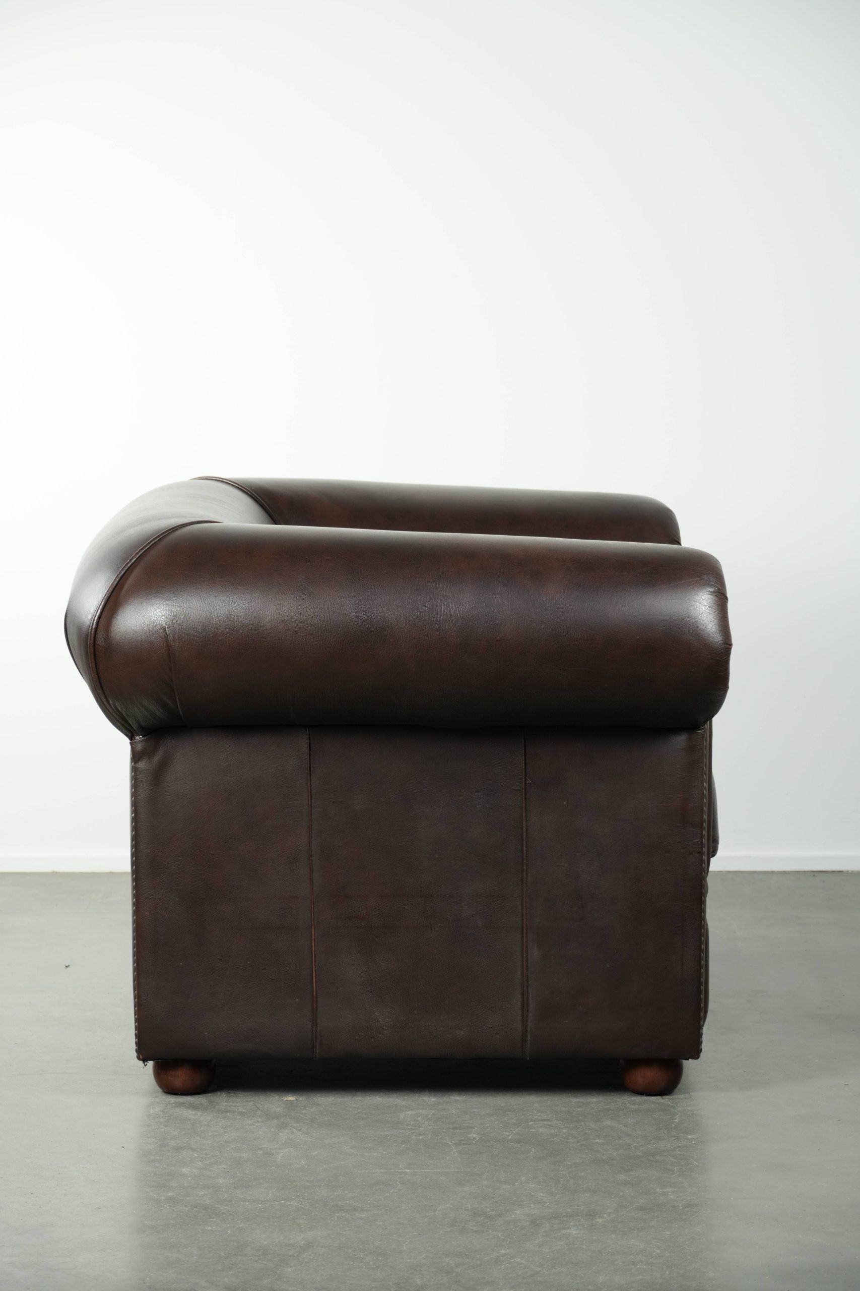 Luxury brown cow leather Chesterfield armchair with a timeless English look