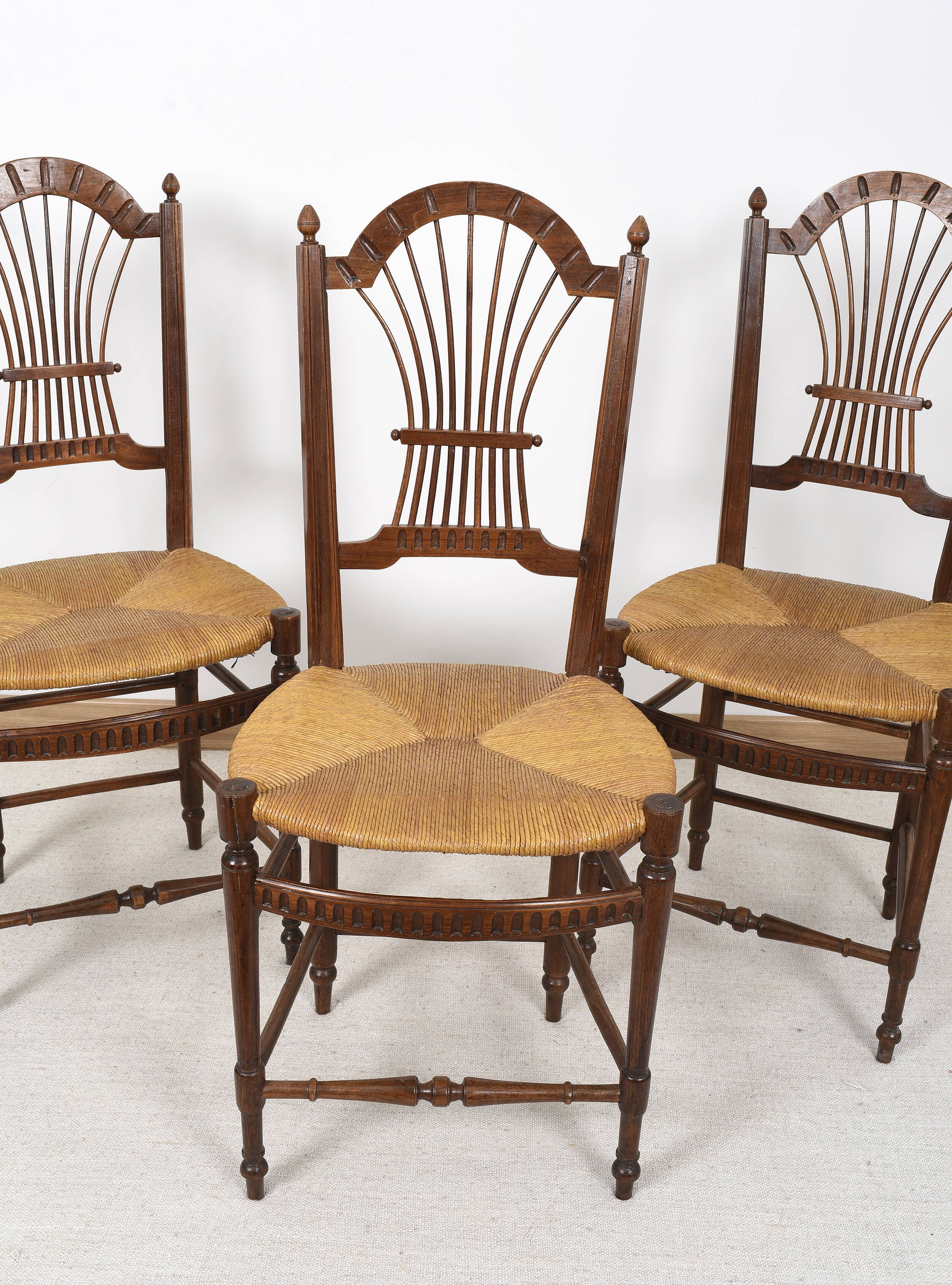 3 wooden and straw chairs, decorated with a sheaf of wheat.