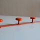 Vintage 70s orange lacquered metal 4-hook wall coat rack