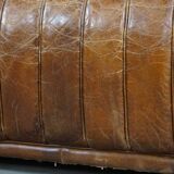 Cognac-colored cowhide 2-seater designer sofa finished with piping