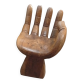 Teak wood stool in the shape of a right hand.