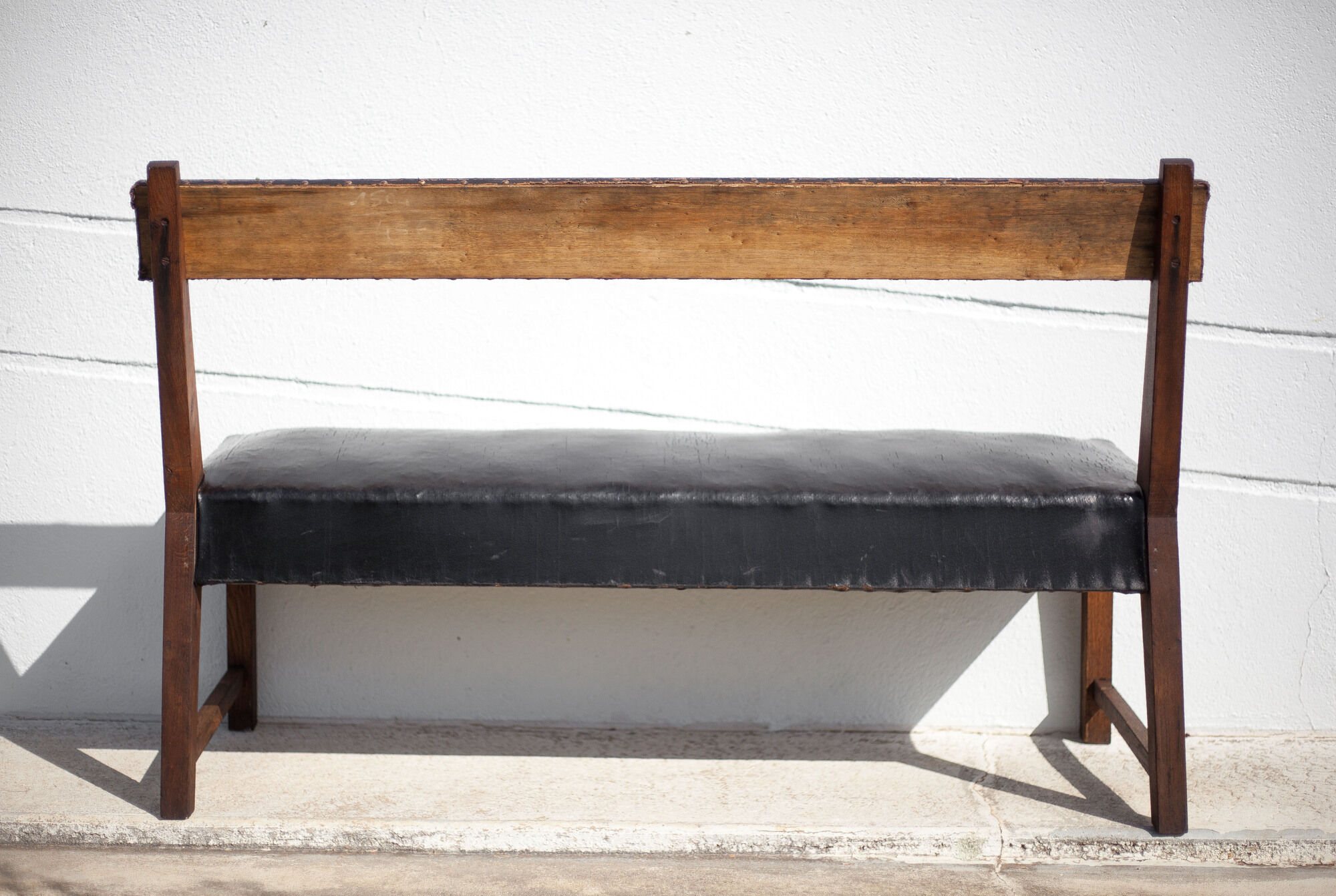Antique wood bench and black imitation leather
