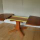 Baumann oval walnut table with extension cords