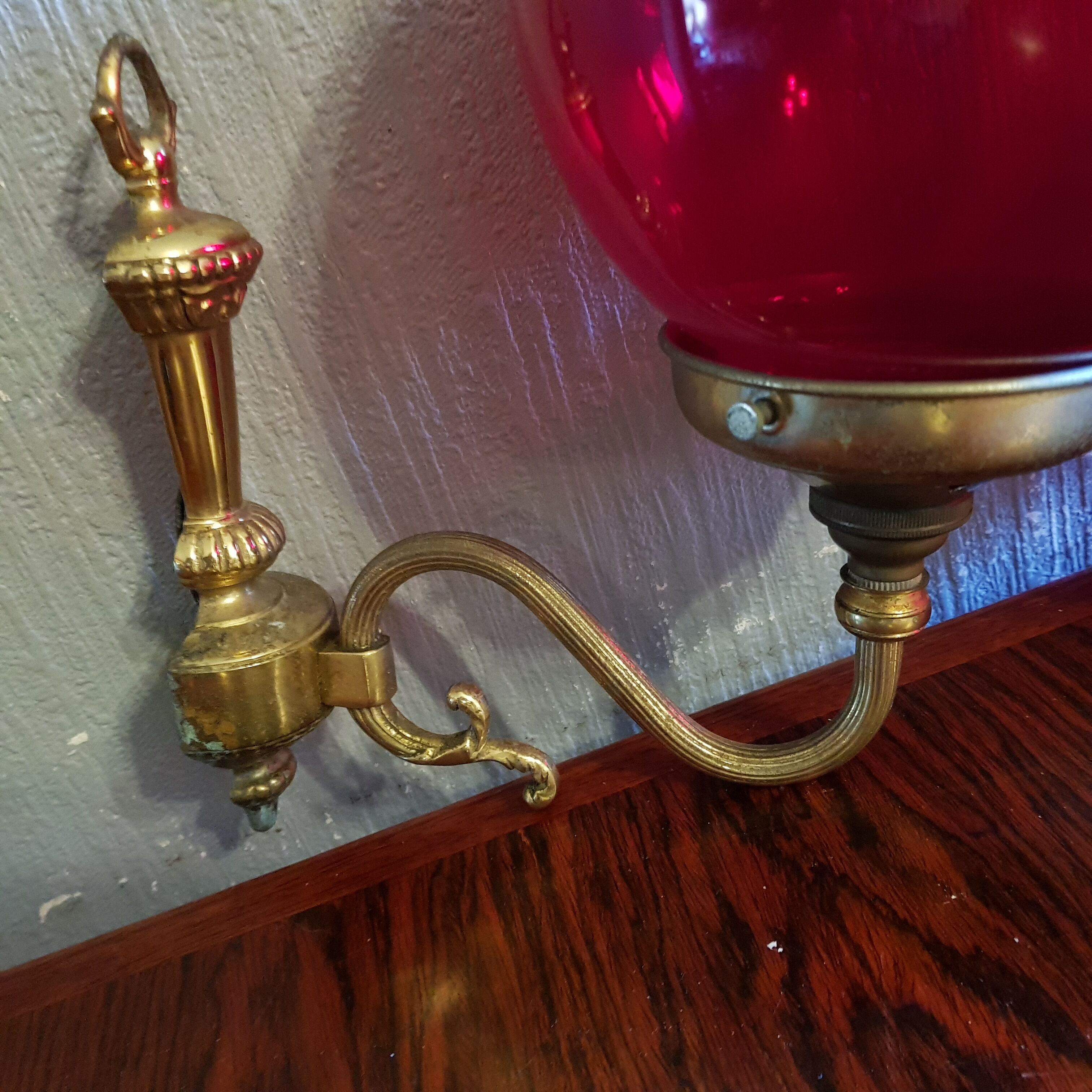Pair of vintage brass wall light and cherry red globe