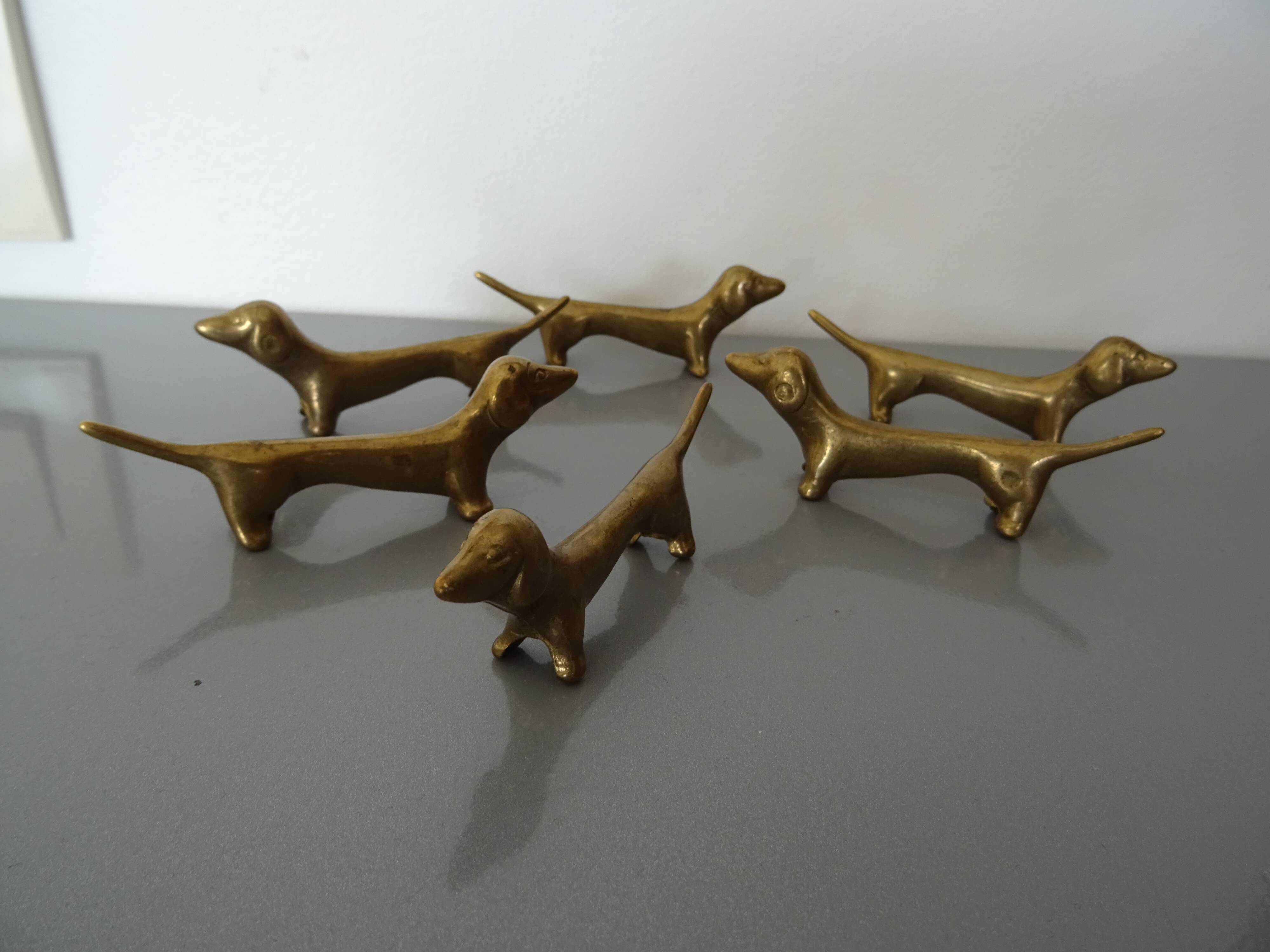 Series of 6 vintage gilded brass dachshund knife holders