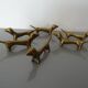 Series of 6 vintage gilded brass dachshund knife holders