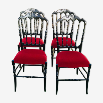 4 black reception chairs with red seats