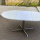 White dining table with a central pedestal, extendable, from the 1970s.