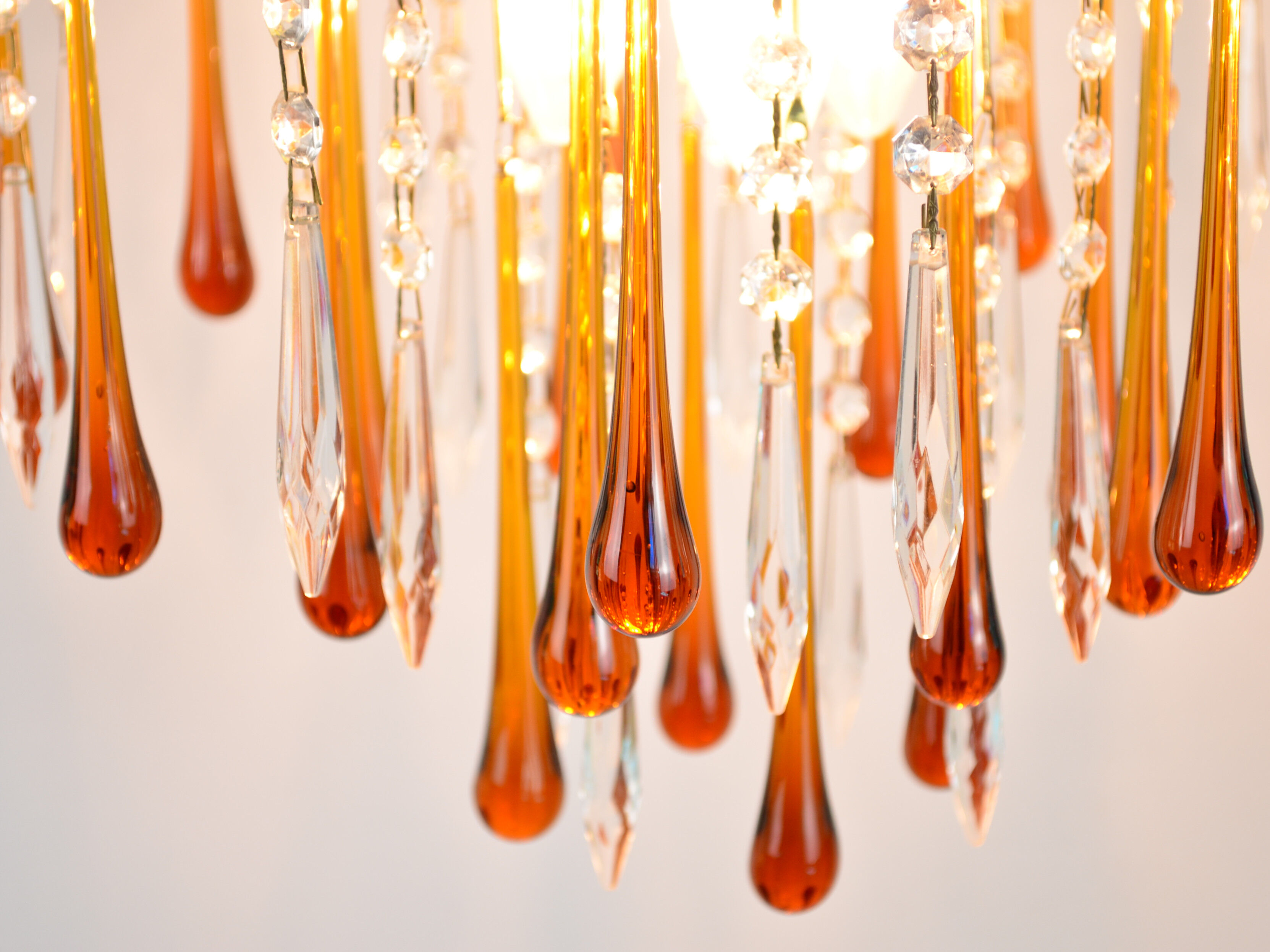 A pair of Mid Century 70's waterfall chandeliers. Murano glass amber drops. Paolo Venini style.
