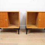 A pair of vintage mid-century bedside tables with oak sliding doors