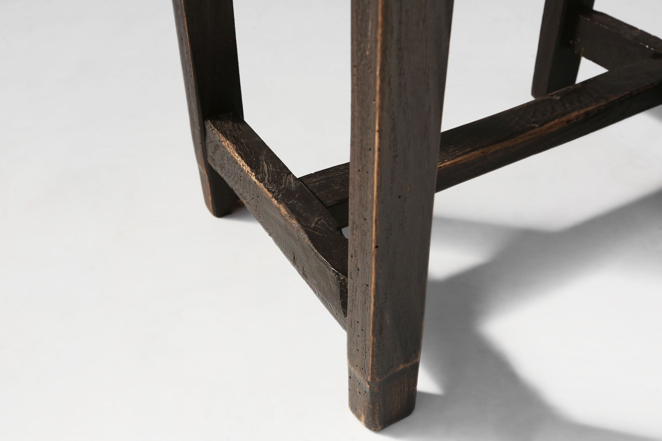 Rustic black wooden stool, Ca.1920