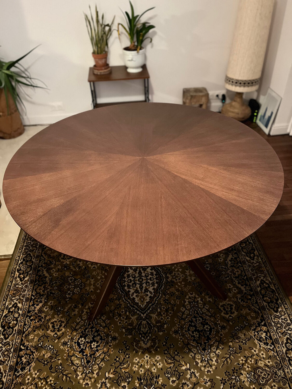 Round table made of solid wood with a walnut finish top.